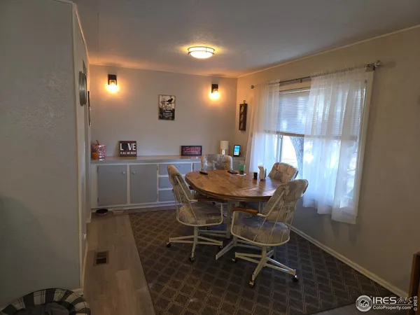 a view of a dining room with furniture and window