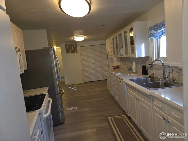 a kitchen with a sink and refrigerator