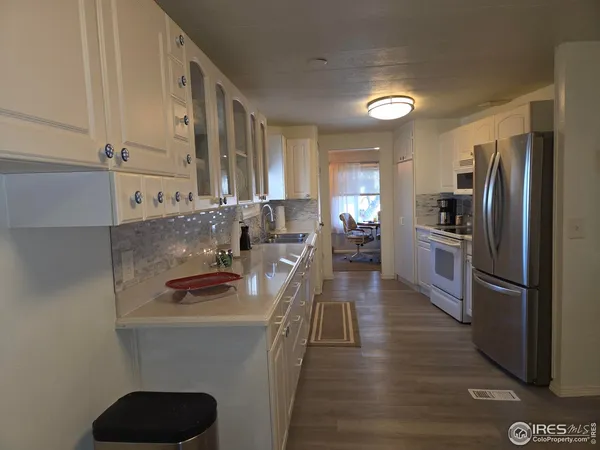 a kitchen with stainless steel appliances a sink stove and refrigerator