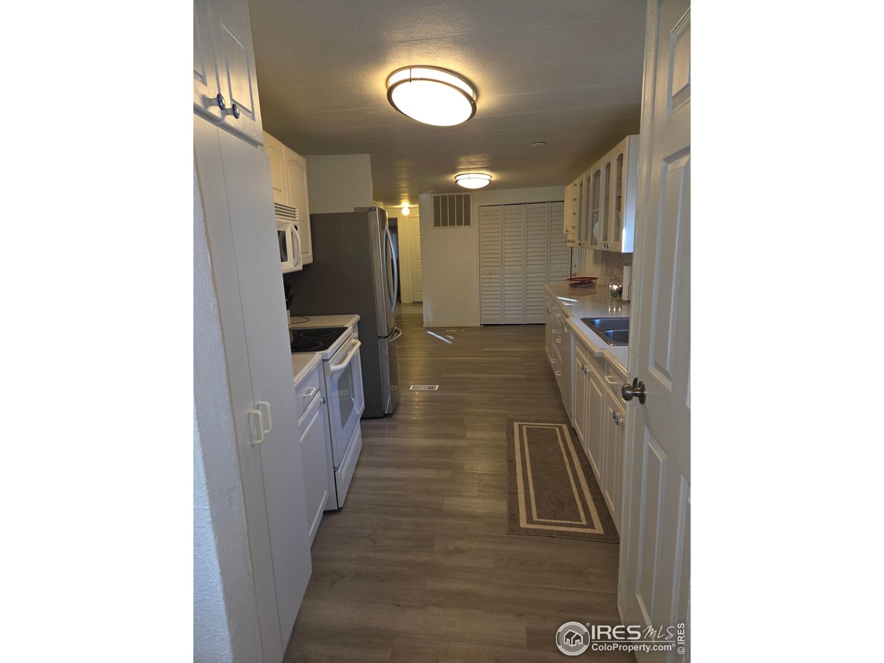 15296 County Road 39 Sterling, CO 80751 - Photo 17 of 26 a view of a hallway with wooden floor
