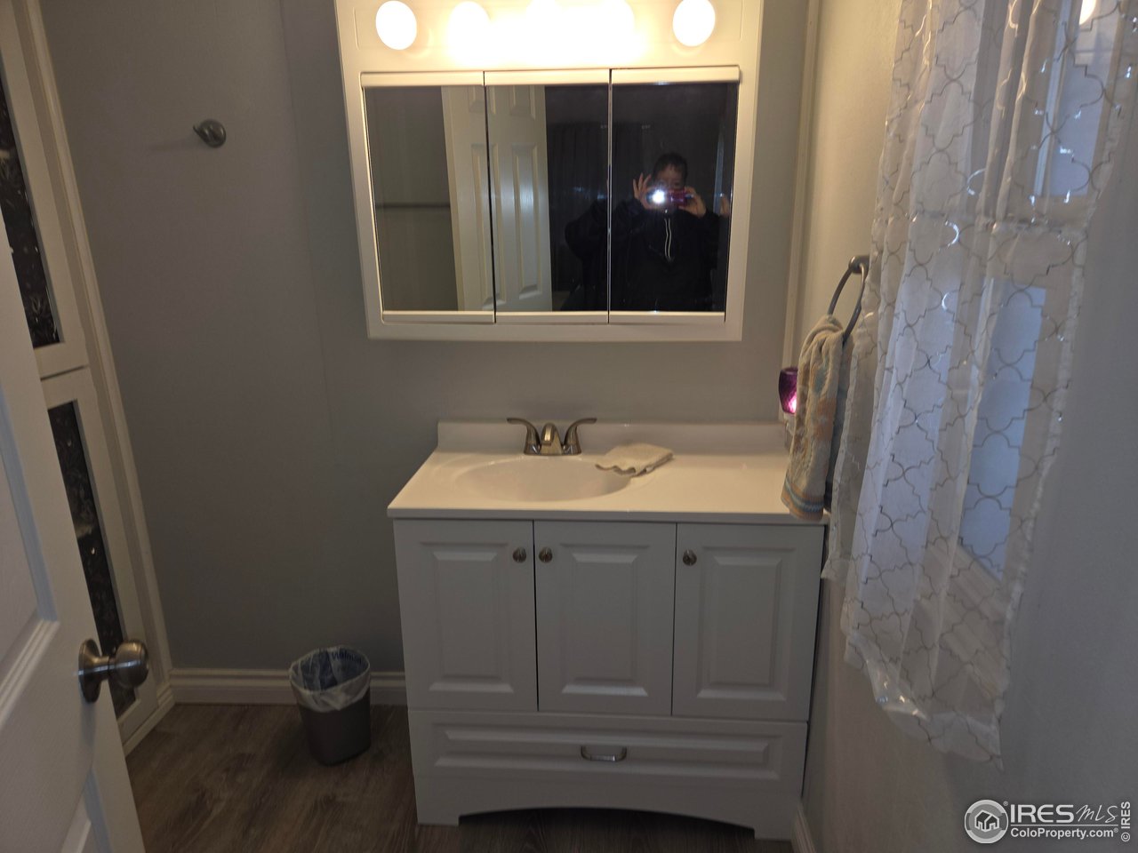 15296 County Road 39 Sterling, CO 80751 - Photo 22 of 26 a bathroom with a sink and mirror