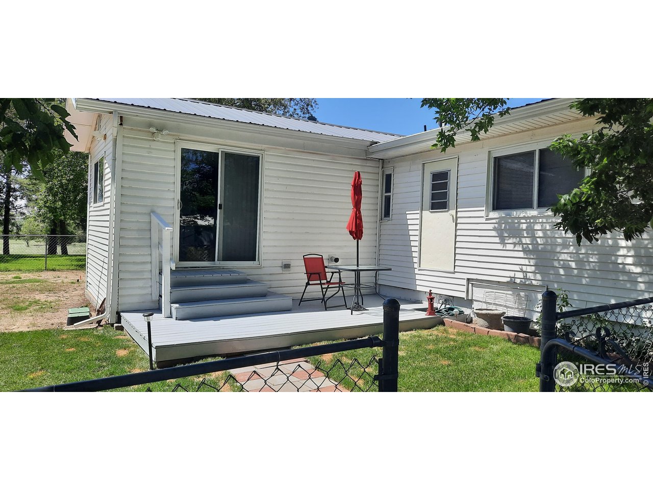 15296 County Road 39 Sterling, CO 80751 - Photo 3 of 26 a view of a house with backyard and a tree