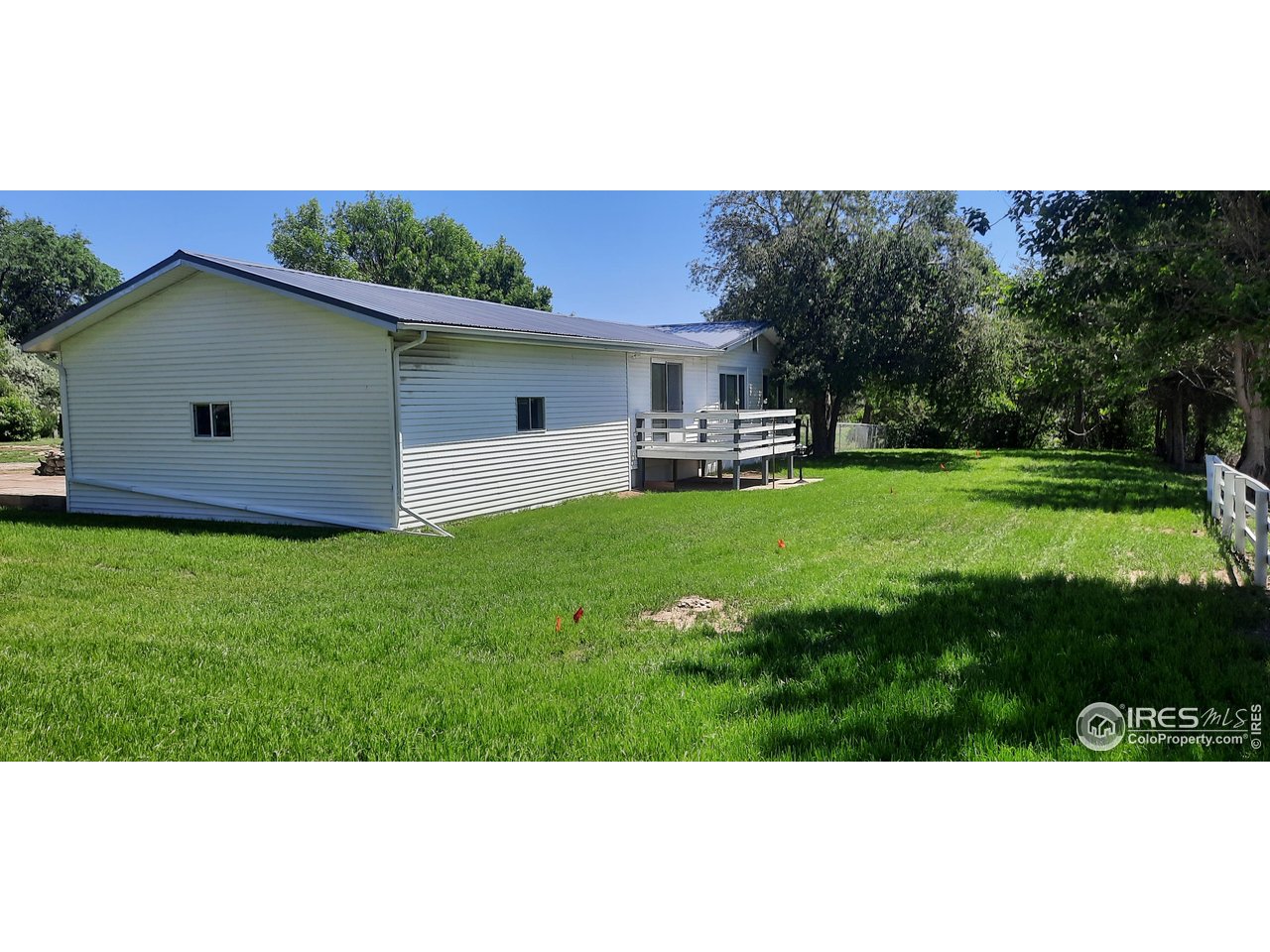 15296 County Road 39 Sterling, CO 80751 - Photo 4 of 26 a backyard of a house with table and chairs