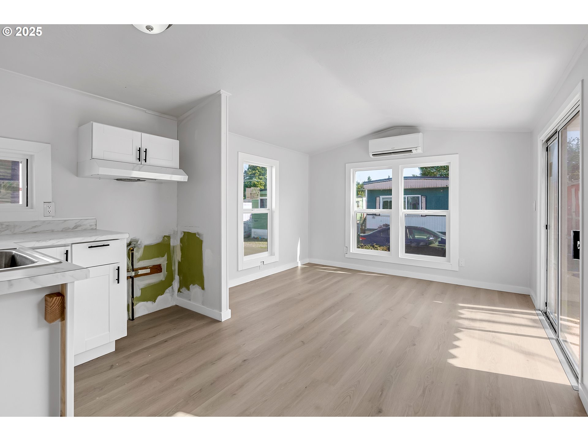 12726 Southeast Division Street, Unit 17 Portland, OR 97236 - Photo 16 of 26 a view of a kitchen with fridge and wooden floor