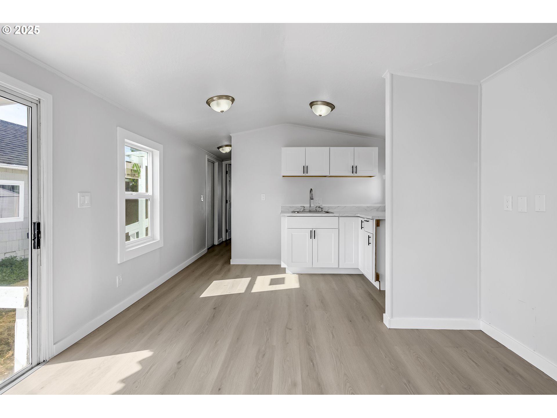 12726 Southeast Division Street, Unit 17 Portland, OR 97236 - Photo 18 of 26 a open kitchen with cabinets and wooden floor