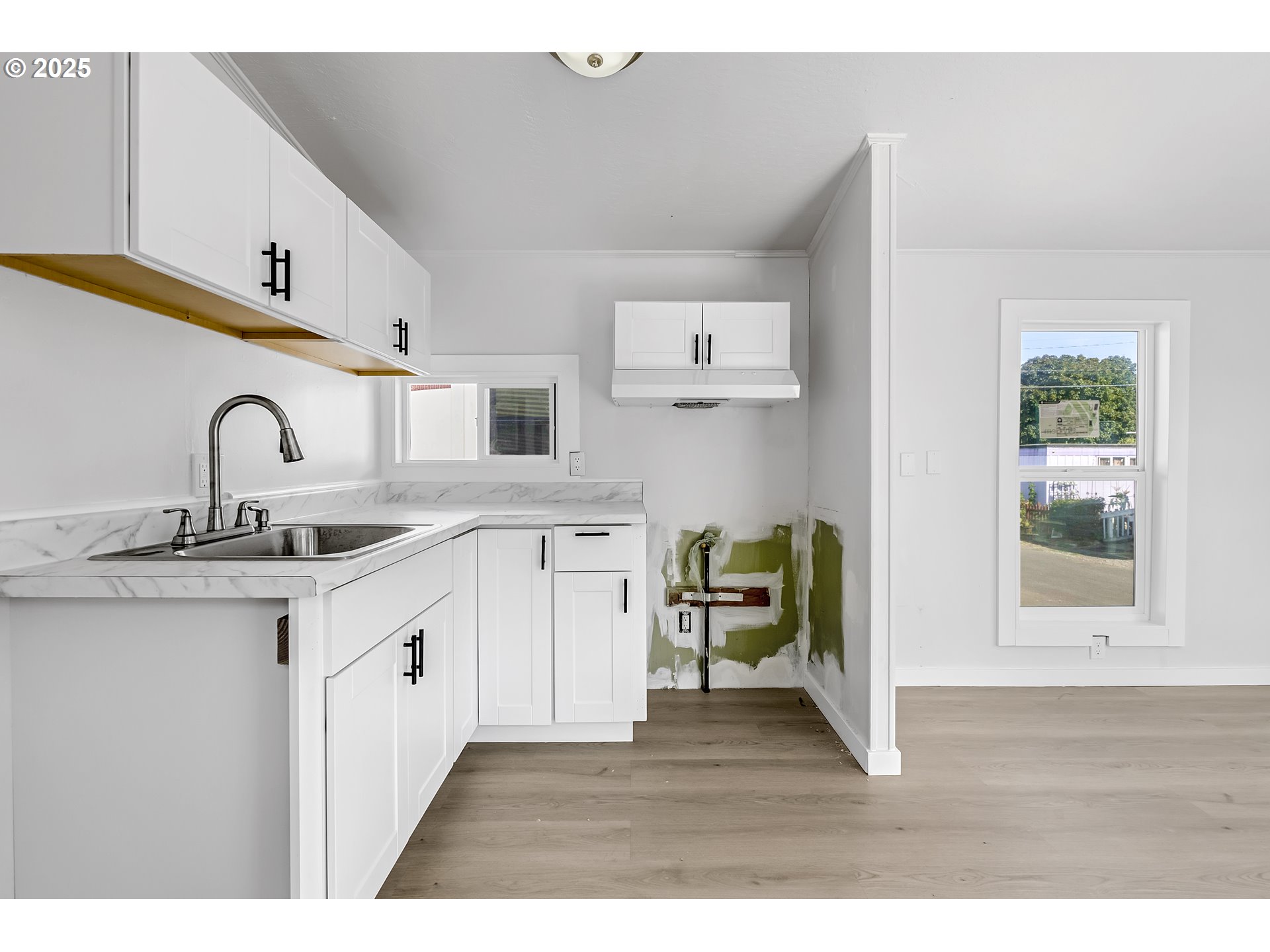 12726 Southeast Division Street, Unit 17 Portland, OR 97236 - Photo 20 of 26 a kitchen with a sink cabinets and wooden floor
