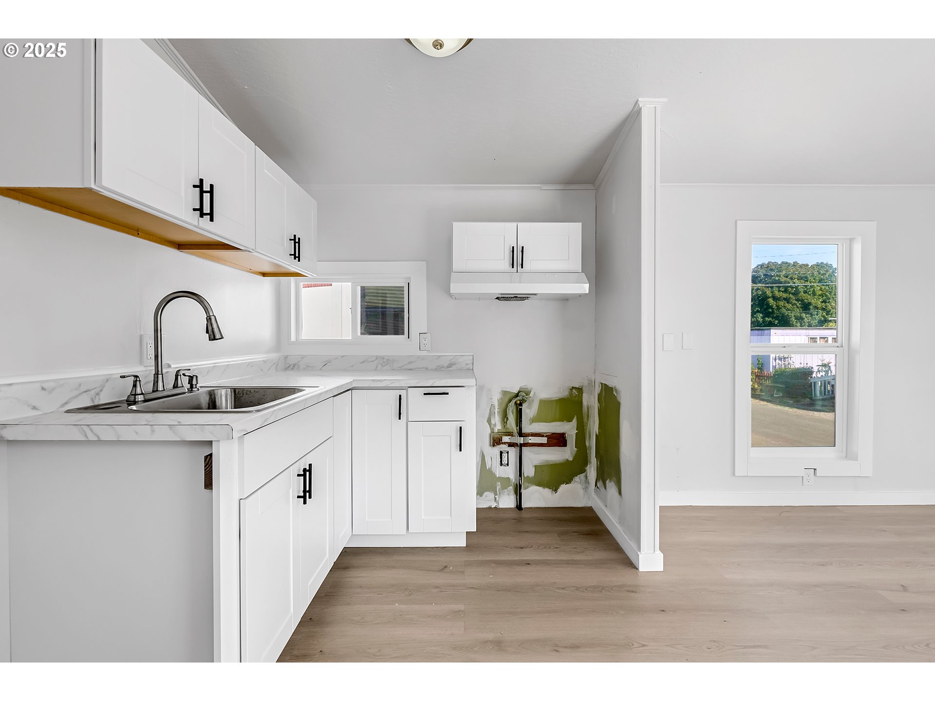 12726 Southeast Division Street, Unit 17 Portland, OR 97236 - Photo 21 of 26 a open kitchen with sink and cabinets