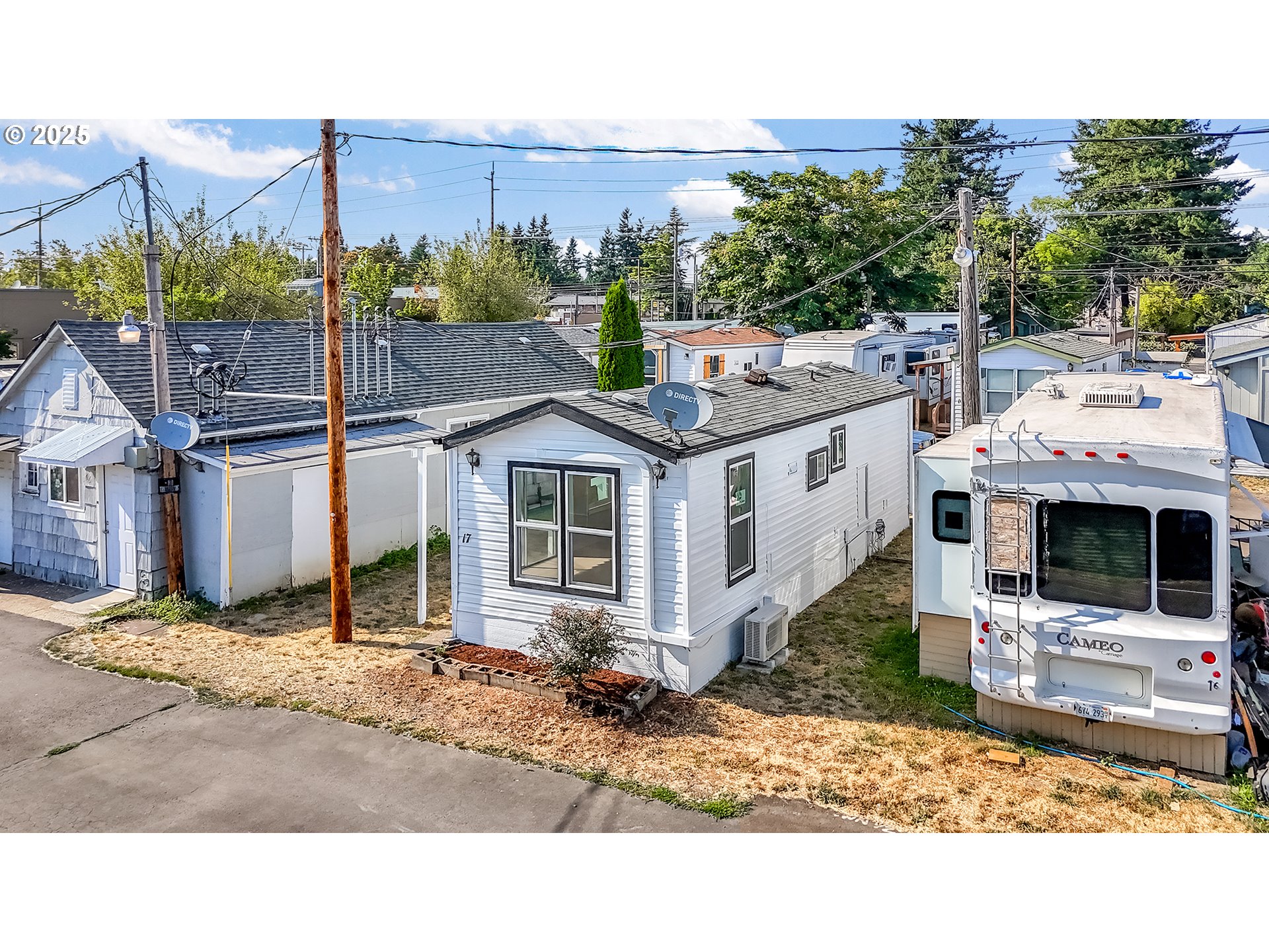 12726 Southeast Division Street, Unit 17 Portland, OR 97236 - Photo 3 of 26 a view of a white house in front of a yard