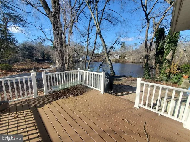 a view of balcony with wooden floor and fence