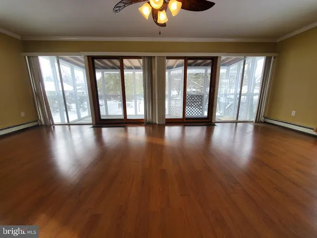 a view of an entryway with wooden floor
