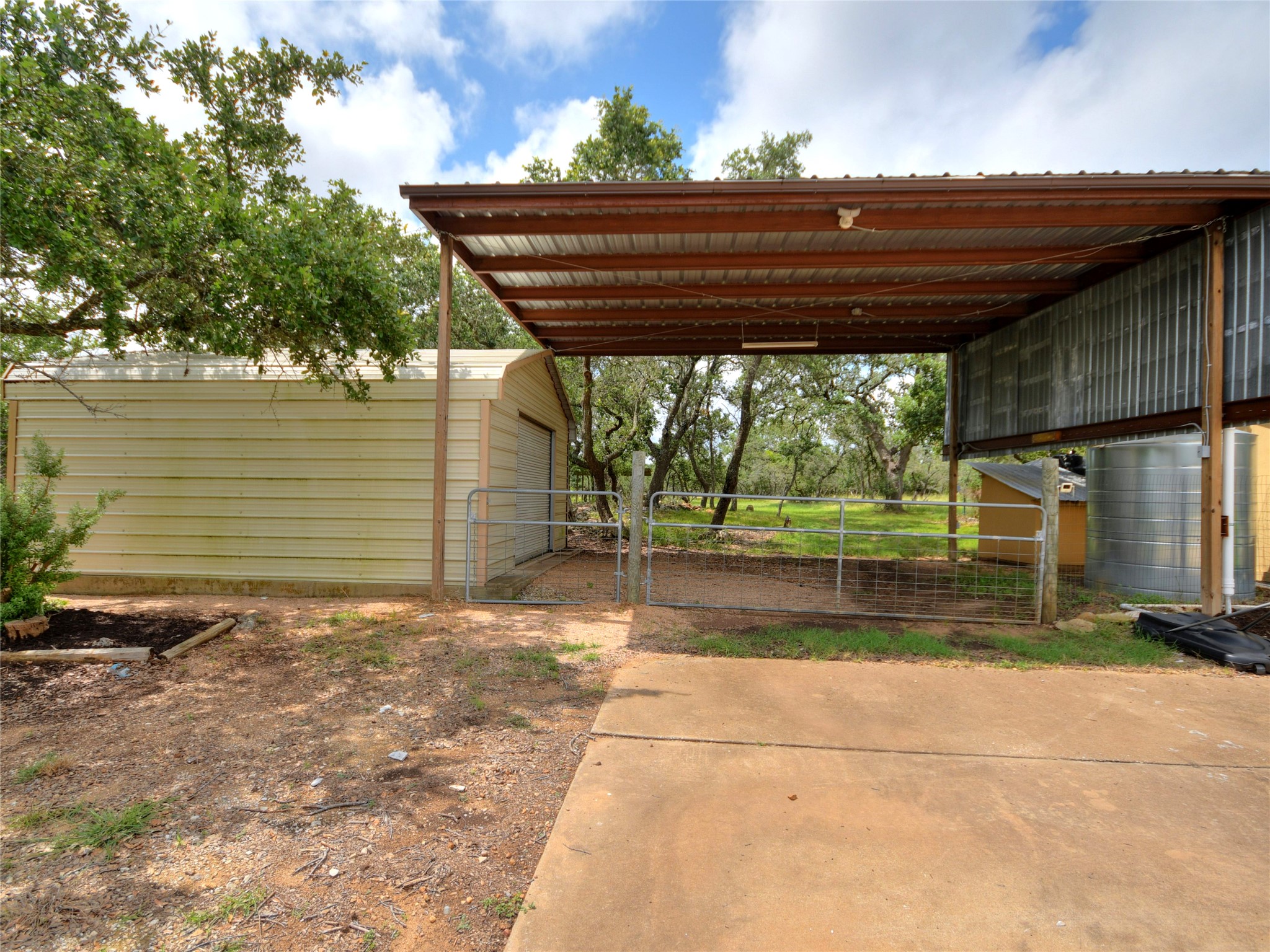 328 Fawnridge Street Georgetown, TX 78628 - Photo 26 of 33 Covered RV storage with light and electricity. 18x18 metal workshop.