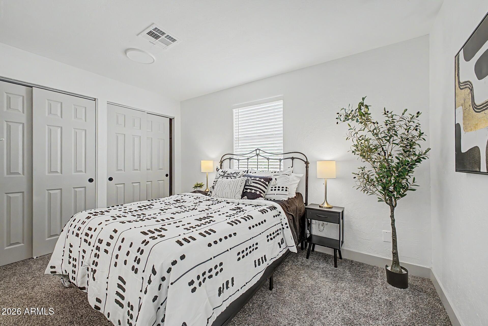 1914 East Monte Vista Road Phoenix, AZ 85006 - Photo 12 of 26 a bedroom with a bed table flowerpot and window