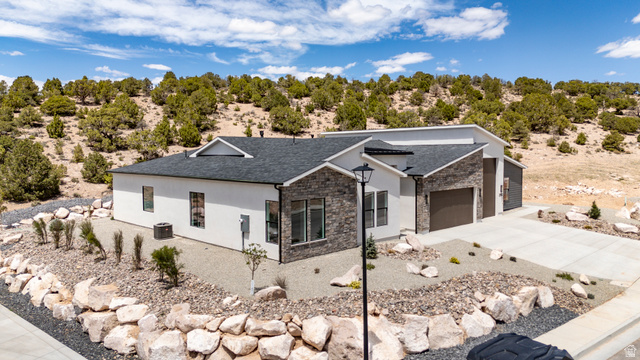 2862 South Mountain Rnch Road Cedar City, UT 84720 - Photo 63 of 64 Modern ranch-style home featuring a dark shingle roof and a two-car garage