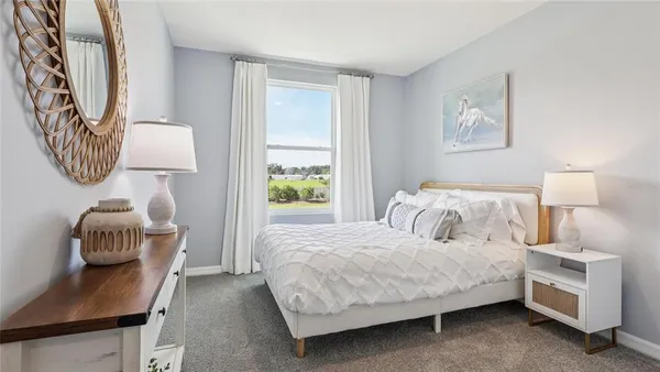a bedroom with a bed and a lamp on table