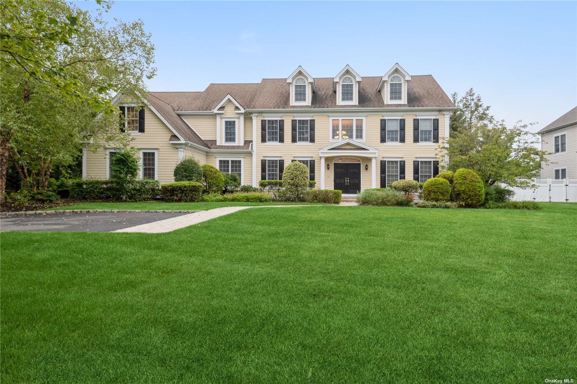 14 Legends Circle Melville, NY 11747 - Photo 1 of 1 a front view of a house with a garden and trees