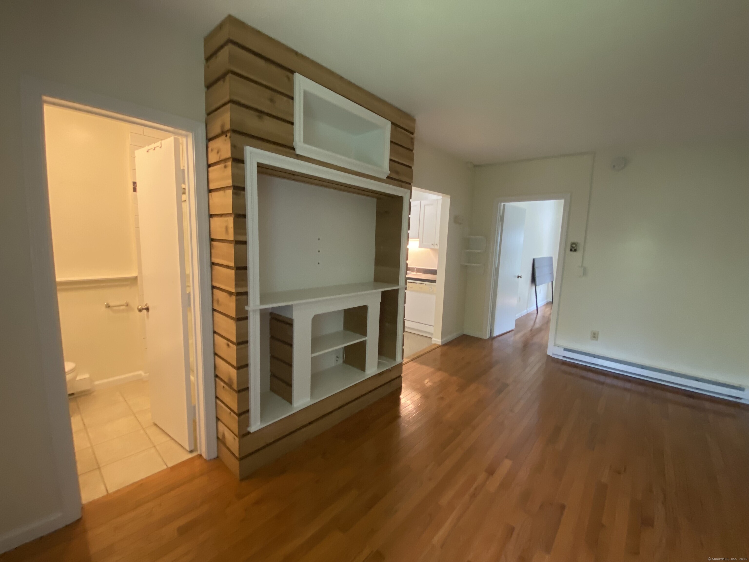 51 Pearl Street Guilford, CT 06437 - Photo 11 of 12 a living room with stainless steel appliances wooden floor and a window