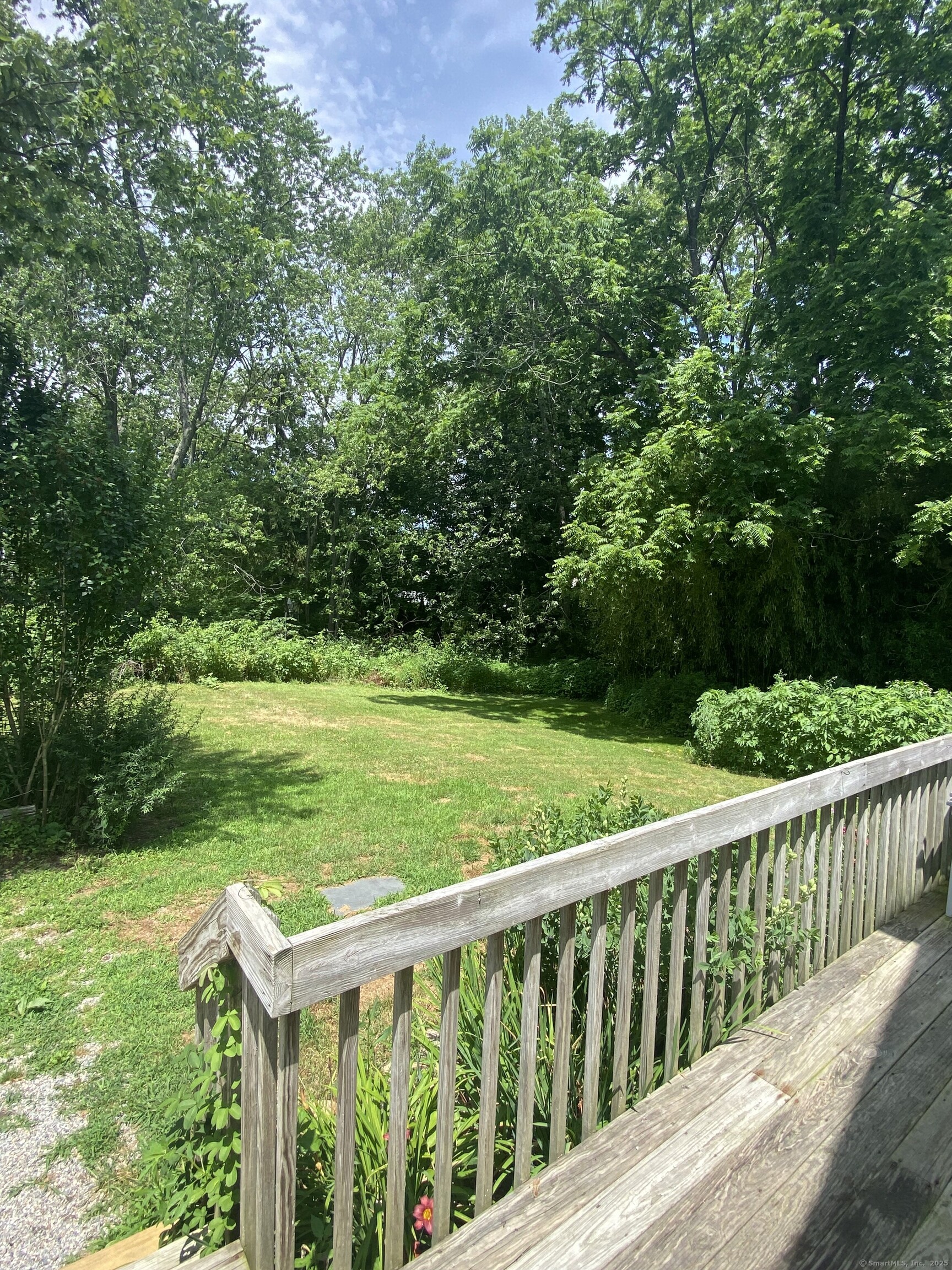 51 Pearl Street Guilford, CT 06437 - Photo 3 of 12 a view of a wooden deck and a yard with lawn chairs