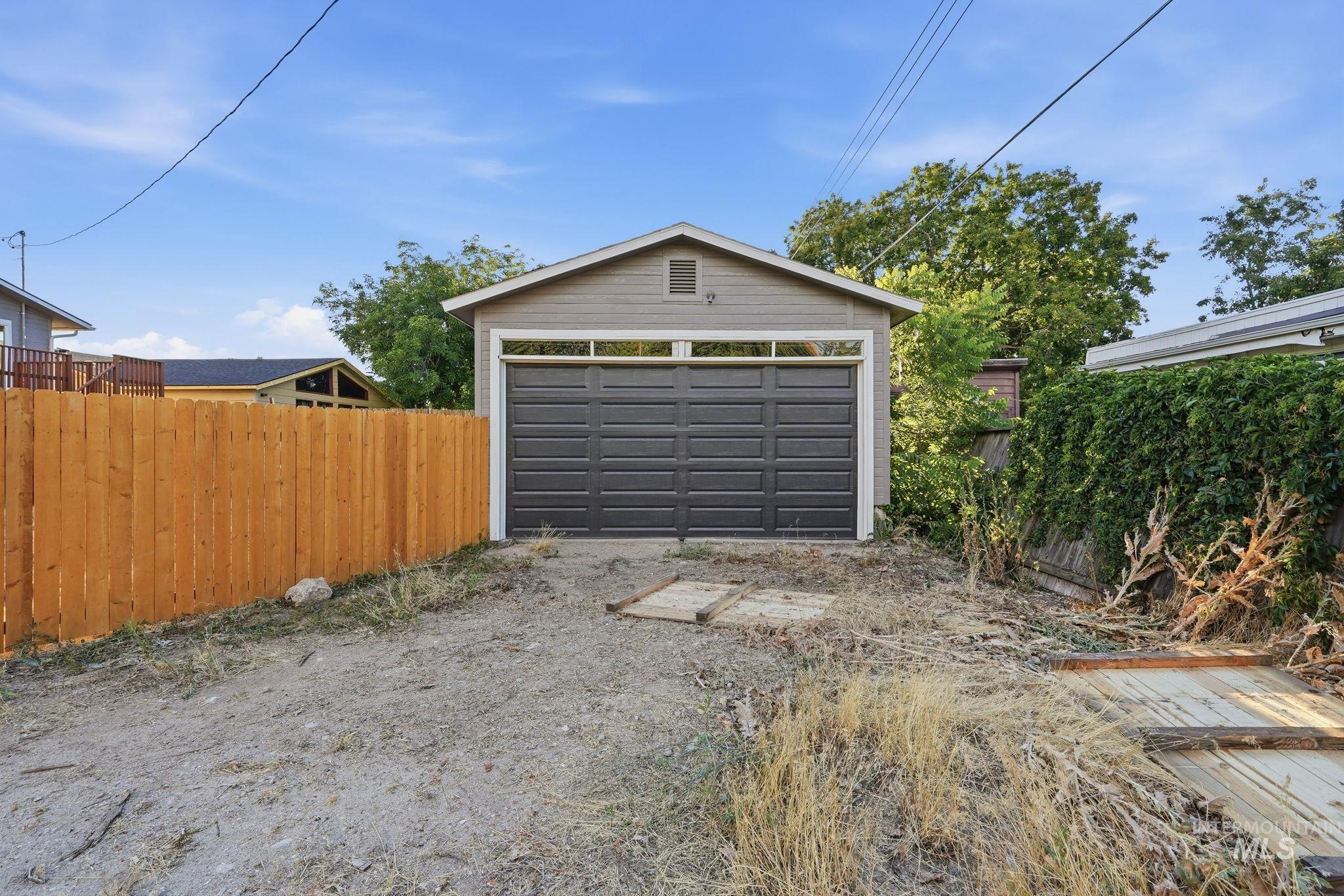 1990 Panama Street Boise, ID 83705 - Photo 43 of 50 Detached garage with horizontal siding and a dark panel garage door