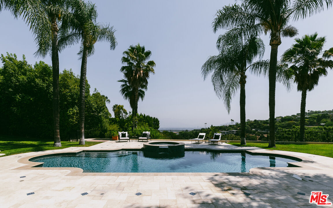 3364 Clerendon Road Beverly Hills, CA 90210 - Photo 14 of 33 a view of swimming pool with a yard and palm trees