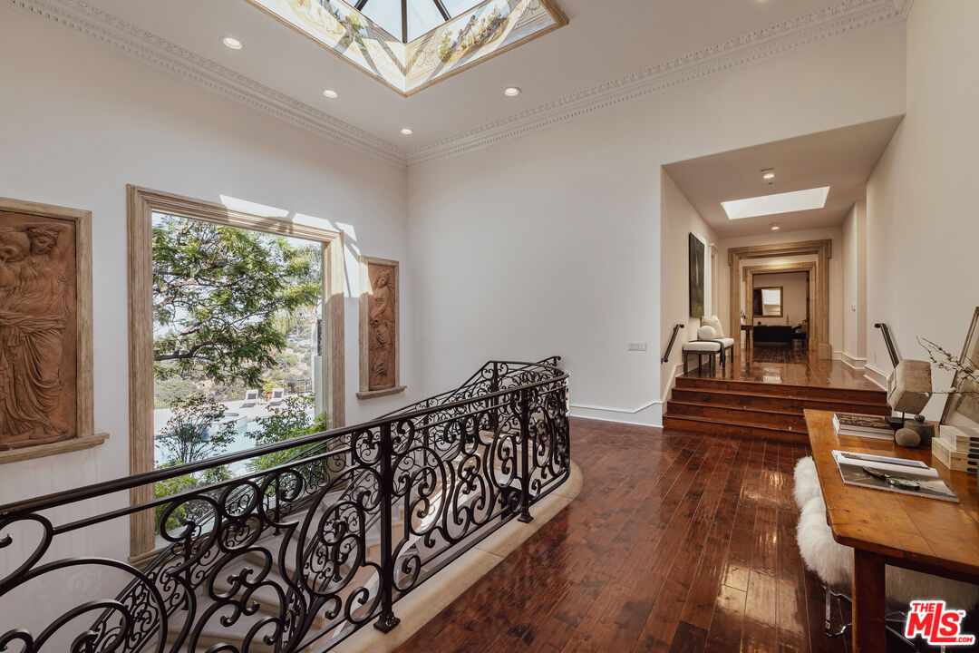 3364 Clerendon Road Beverly Hills, CA 90210 - Photo 16 of 33 a hallway with wooden floor and furniture