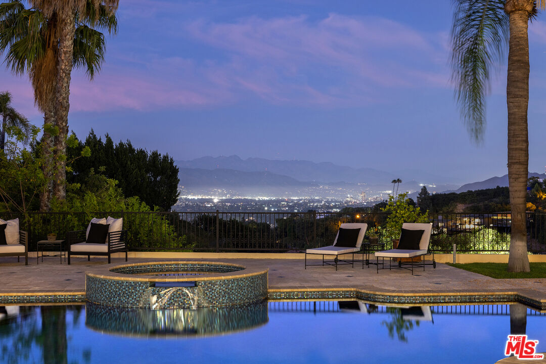 3364 Clerendon Road Beverly Hills, CA 90210 - Photo 31 of 33 a view of a swimming pool with lawn chairs and a potted plants