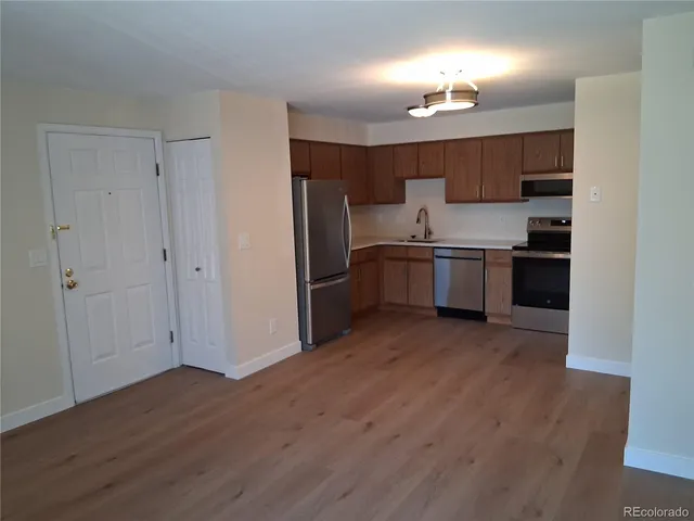 a kitchen with stainless steel appliances granite countertop a stove and a refrigerator