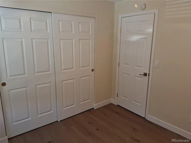 an empty room with wooden floor