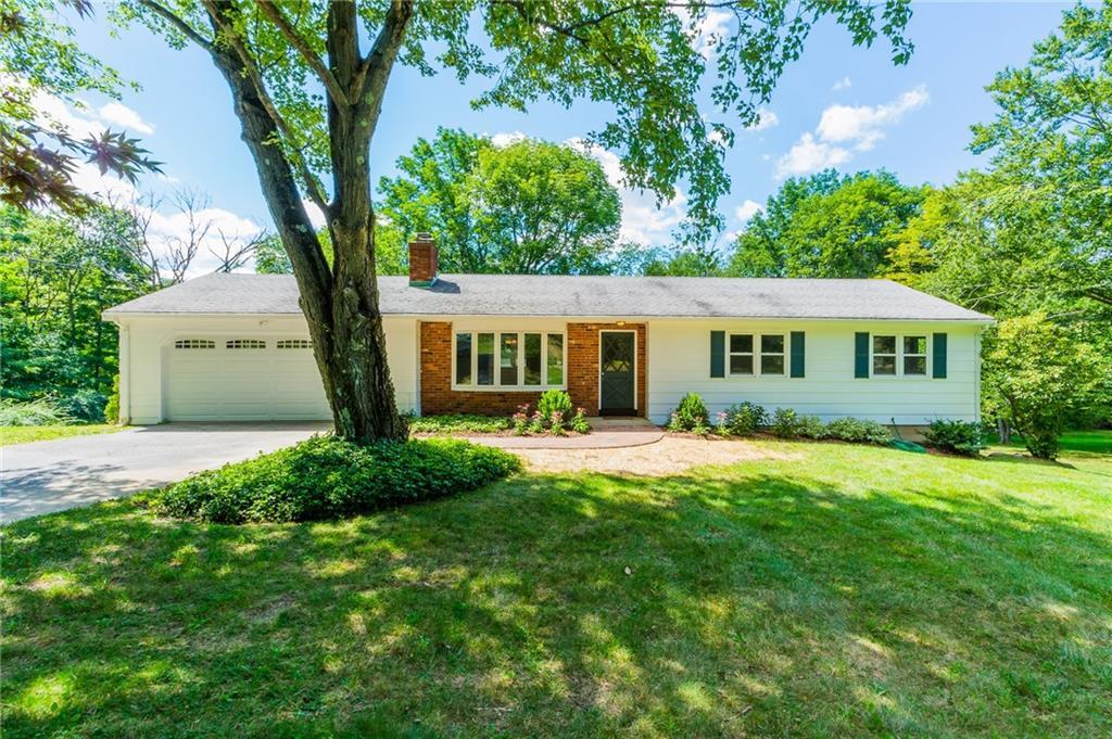 42 Great Hill Road Newtown, CT 06470 - Photo 1 of 1 a front view of a house with a yard and trees