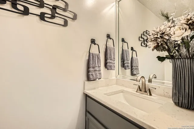 a bathroom with a sink and a mirror