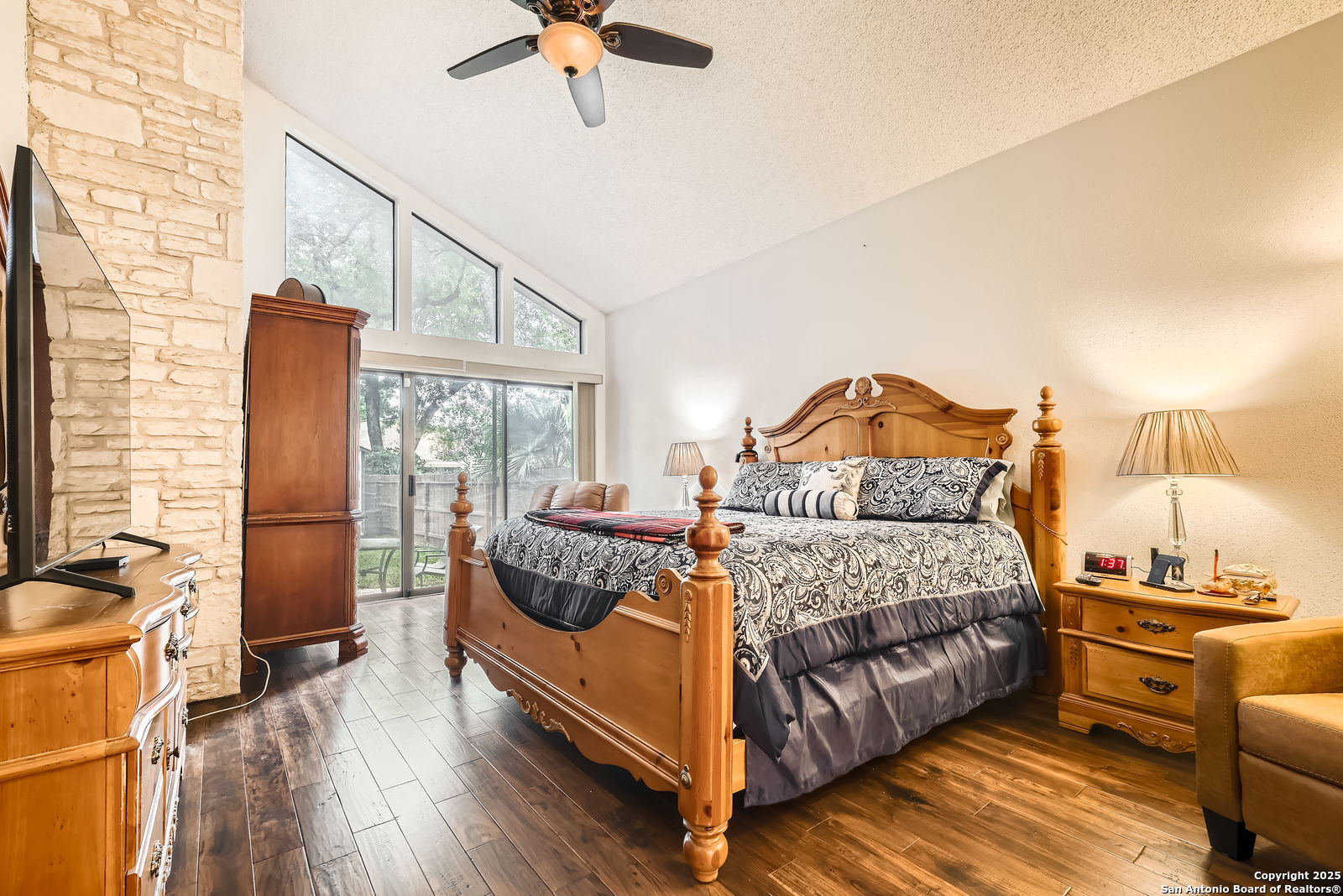 13215 Hunters Spring San Antonio, TX 78230 - Photo 15 of 29 a bedroom with a bed and wooden floor