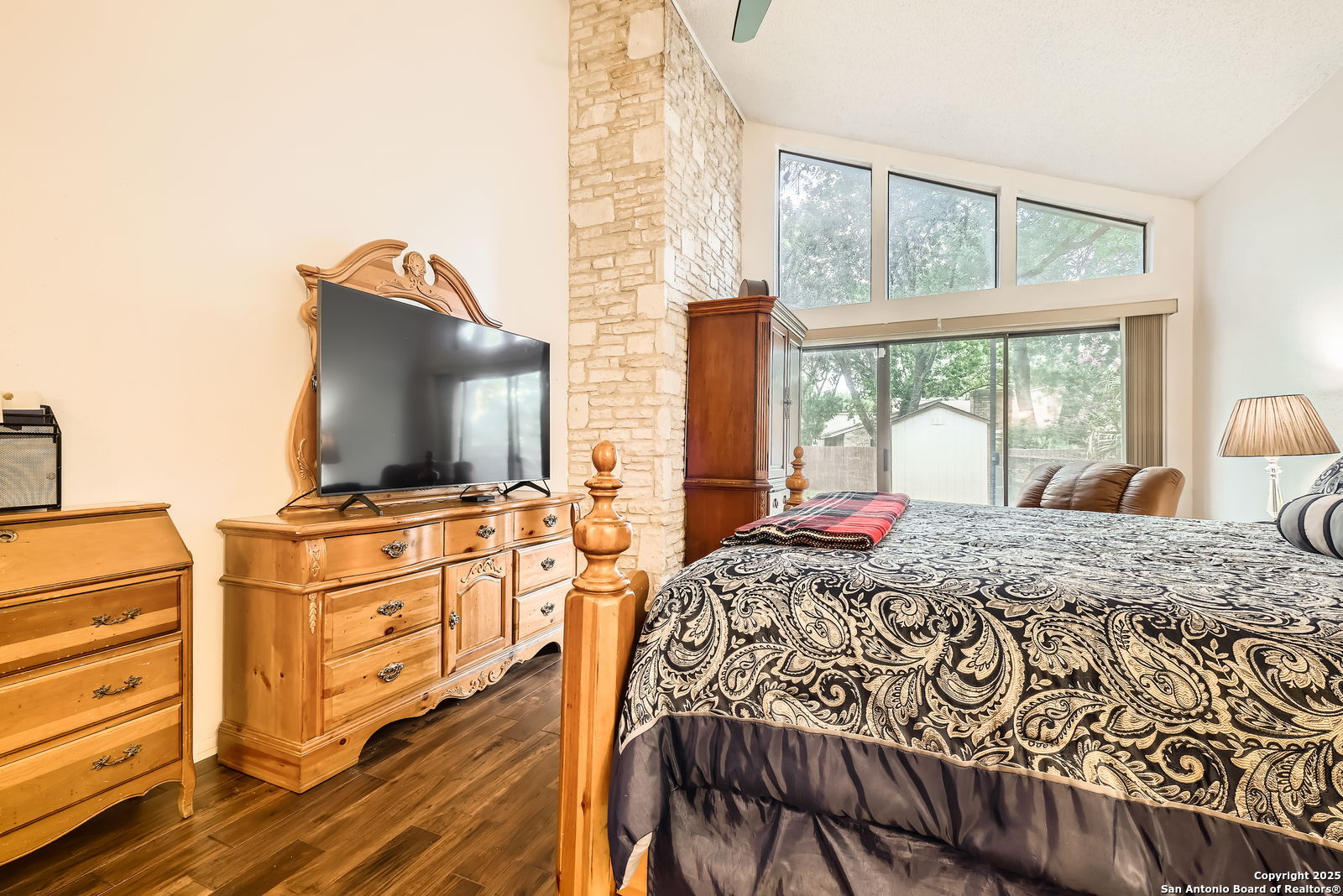 13215 Hunters Spring San Antonio, TX 78230 - Photo 16 of 29 a bedroom with a bed and wooden floor