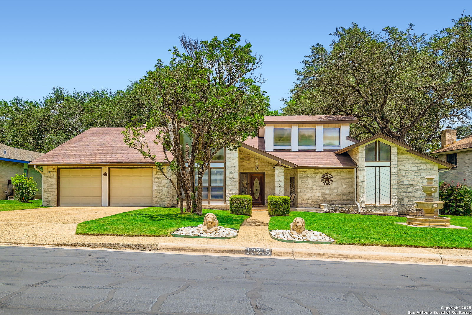 13215 Hunters Spring San Antonio, TX 78230 - Photo 2 of 29 a view of a house with a yard and large tree and plants