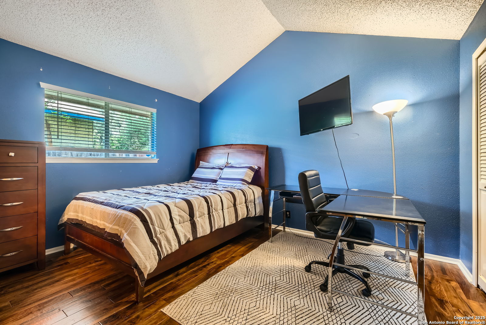 13215 Hunters Spring San Antonio, TX 78230 - Photo 22 of 29 a bedroom with a bed tv and table