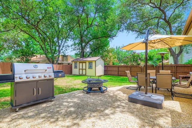 a view of a house with backyard and sitting area