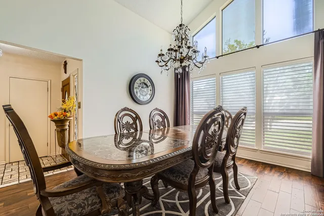 a view of a dining room with furniture and a chandelier