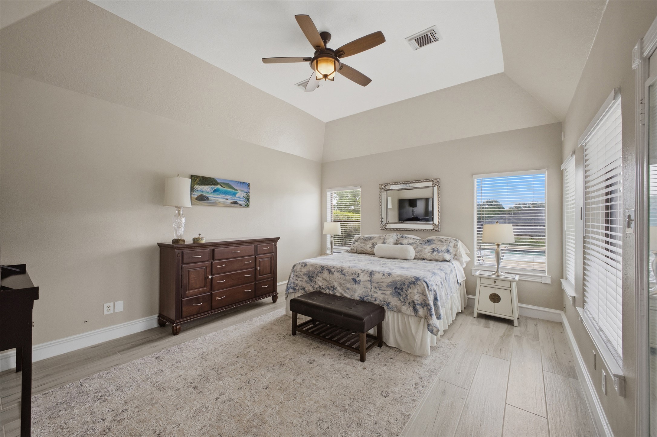 12710 Aries Loop Willis, TX 77318 - Photo 18 of 40 This room features vaulted ceilings with a ceiling fan, light-colored flooring, and windows with blinds
