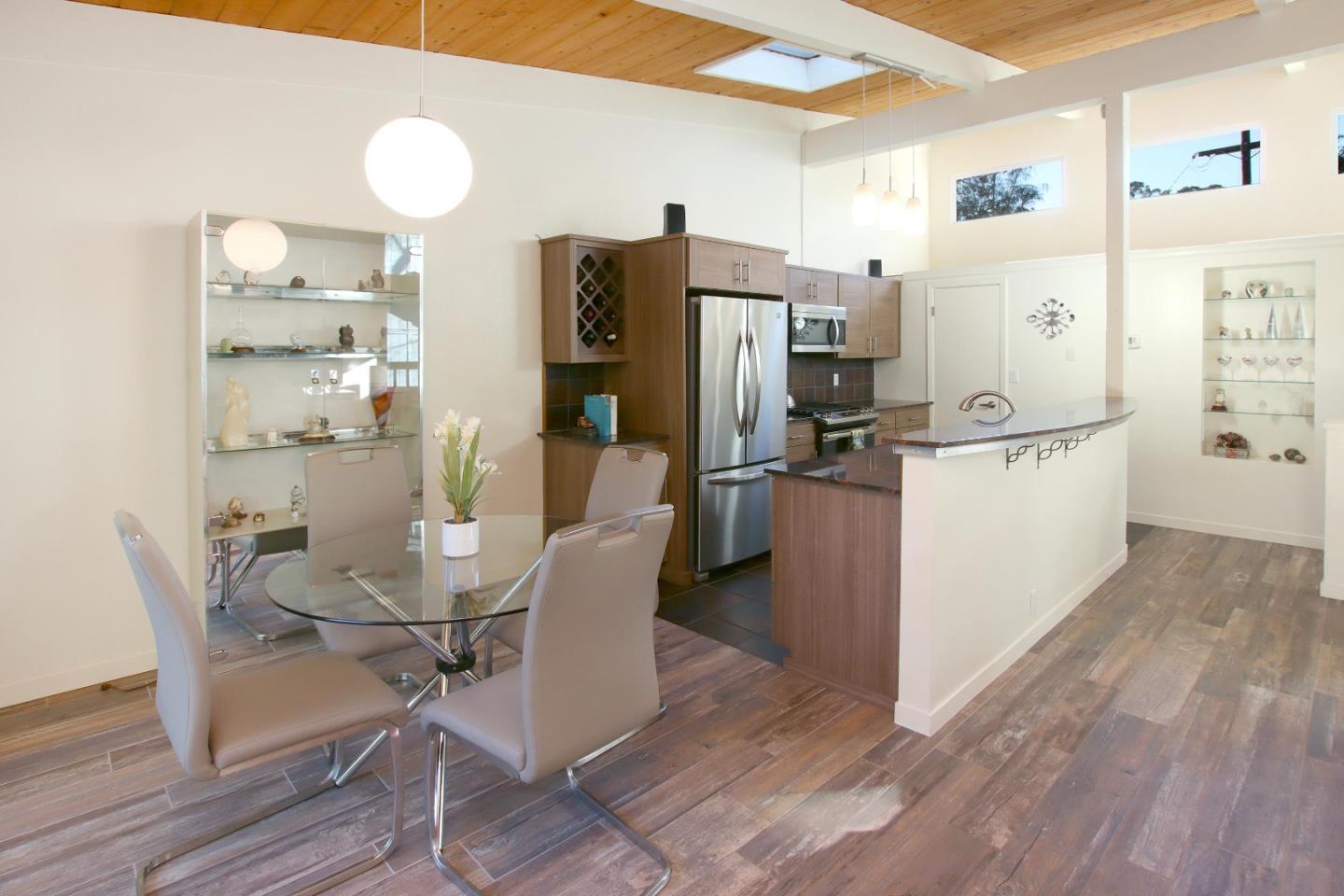 27 Erba Lane Scotts Valley, CA 95066 - Photo 12 of 30 a kitchen with stainless steel appliances a refrigerator a stove a dining table and chairs