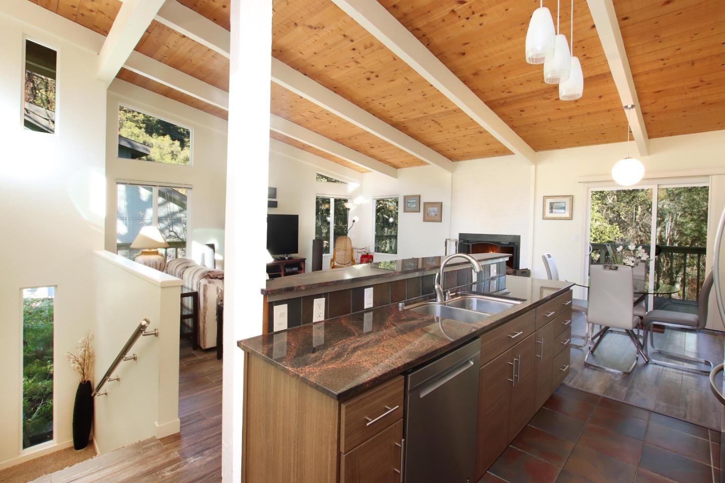 27 Erba Lane Scotts Valley, CA 95066 - Photo 6 of 30 a dining hall with stainless steel appliances granite countertop a sink dishwasher and a black countertops with wooden floor