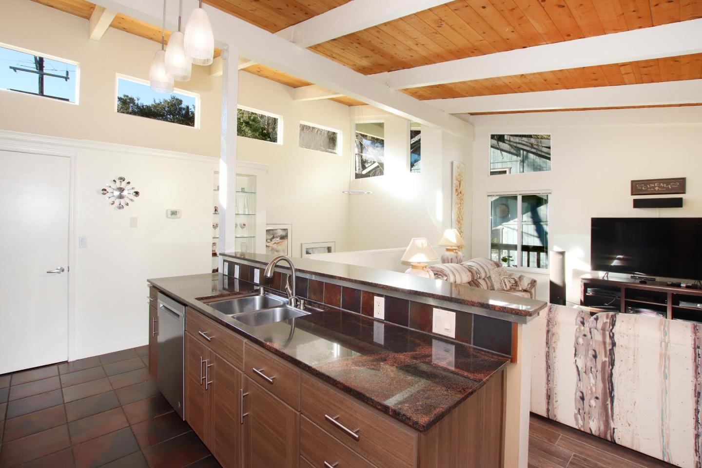 27 Erba Lane Scotts Valley, CA 95066 - Photo 7 of 30 a living room with stainless steel appliances kitchen island granite countertop a sink and a flat screen tv