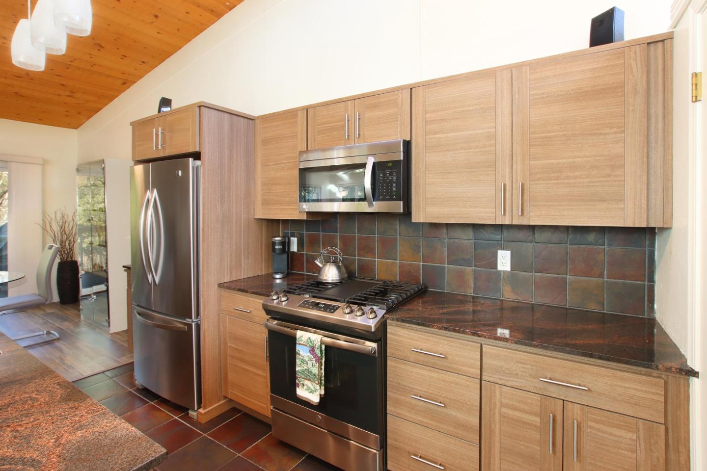 27 Erba Lane Scotts Valley, CA 95066 - Photo 8 of 30 a kitchen with stainless steel appliances granite countertop a refrigerator a stove and a sink
