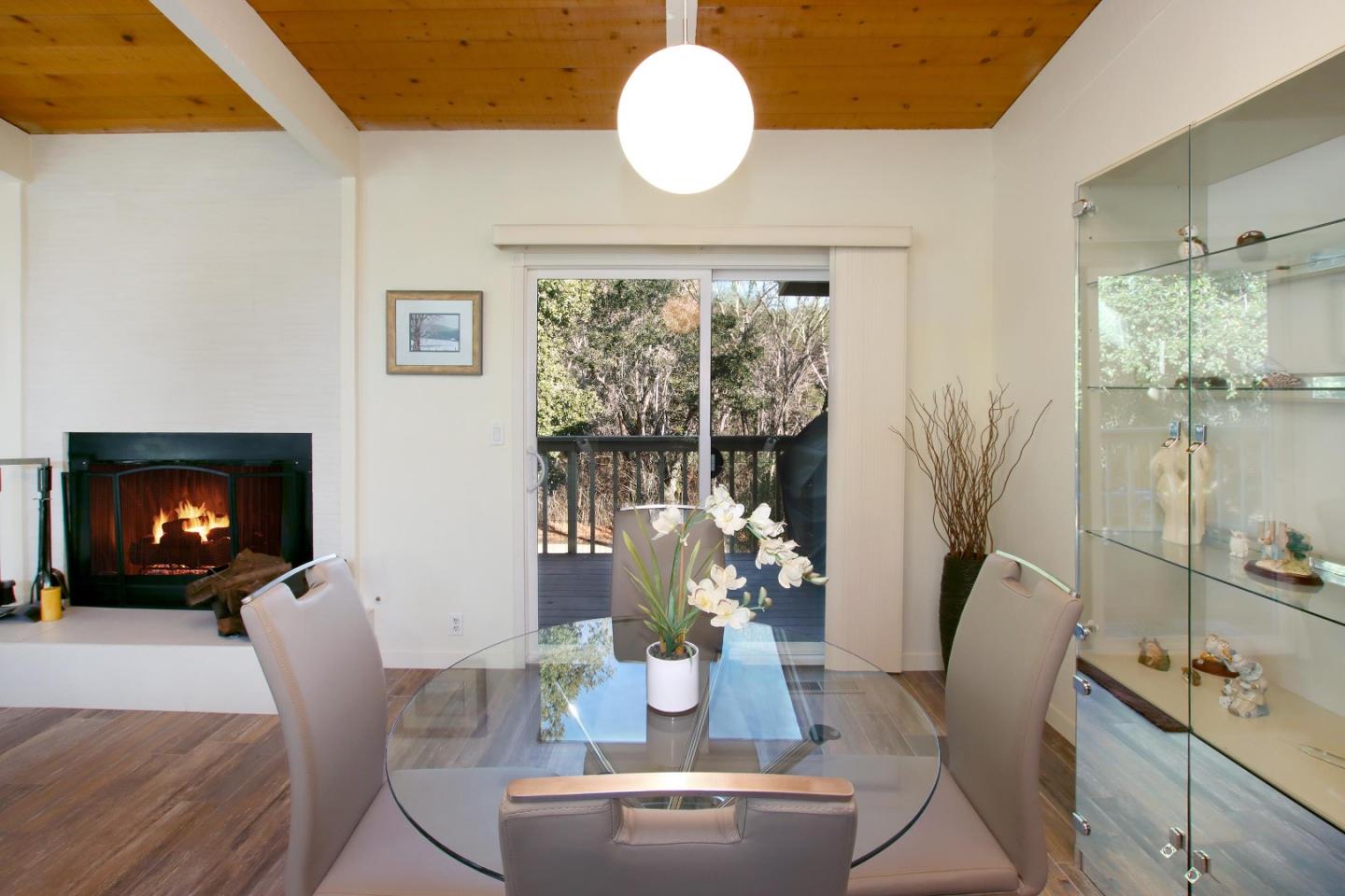 27 Erba Lane Scotts Valley, CA 95066 - Photo 9 of 30 a dining room with furniture a fireplace and large windows