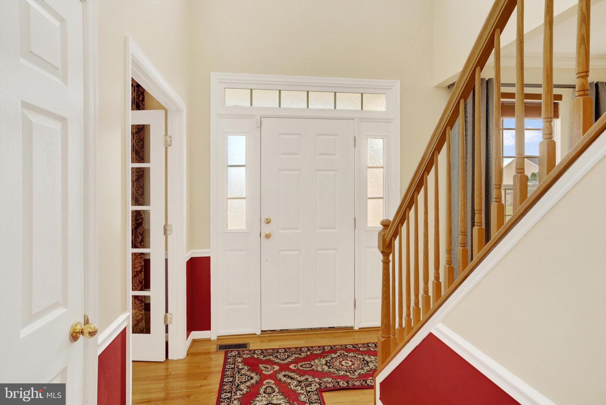 5904 Union Ridge Drive Adamstown, MD 21710 - Photo 6 of 51 a view of an entryway with wooden floor and door