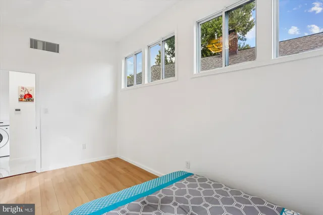 a view of an empty room with wooden floor
