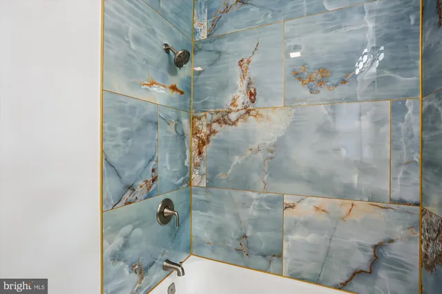 a bathroom with a sink mirror and toilet