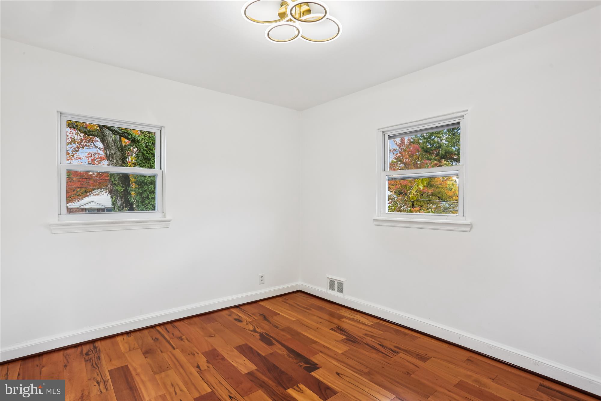 717 Ludlow Street Takoma Park, MD 20912 - Photo 37 of 68 a view of an empty room with wooden floor and a window