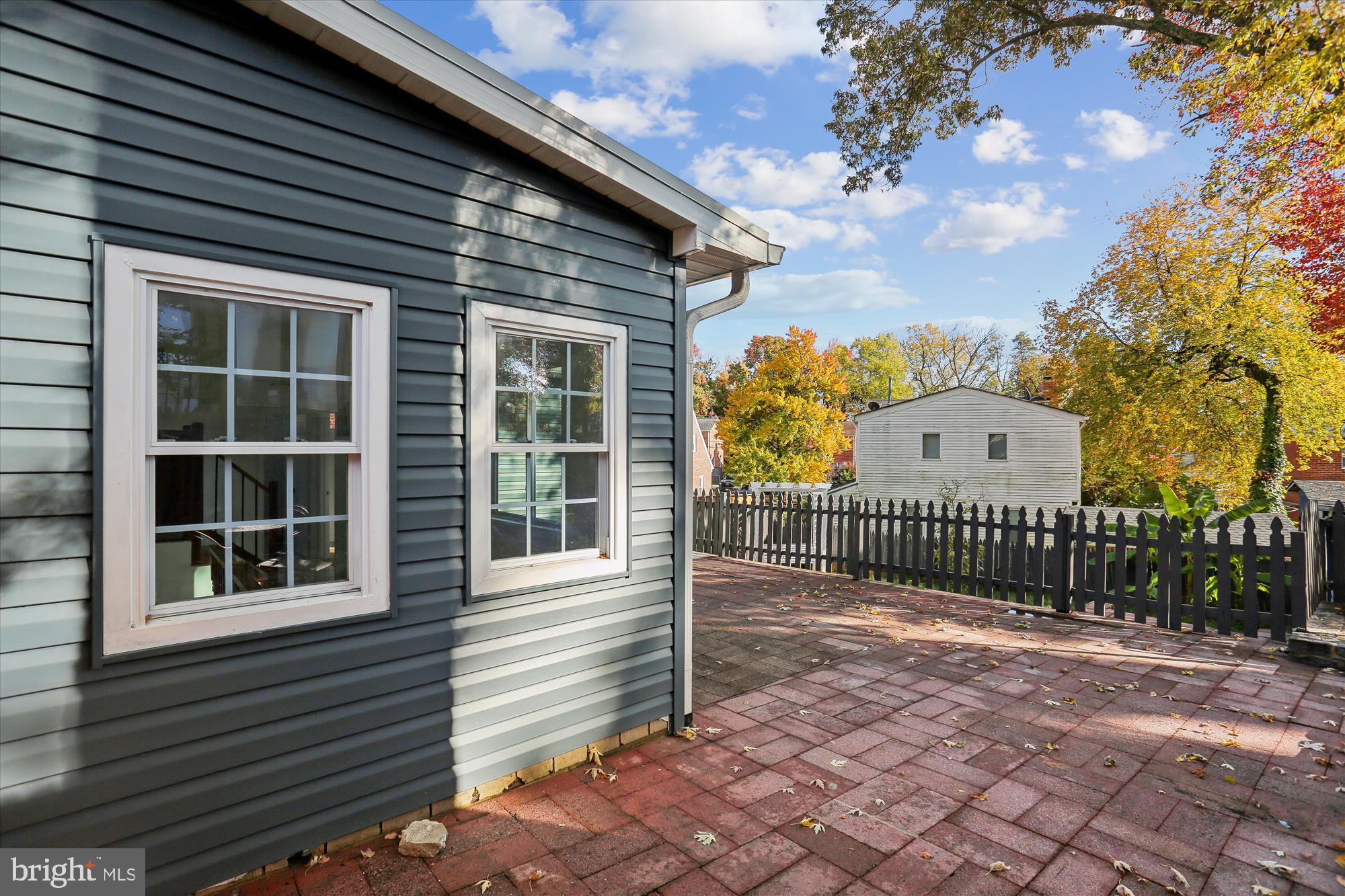 717 Ludlow Street Takoma Park, MD 20912 - Photo 62 of 68 a view of a brick house with a large window and wooden fence