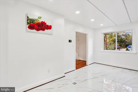 a view of room with stairs and wooden floor