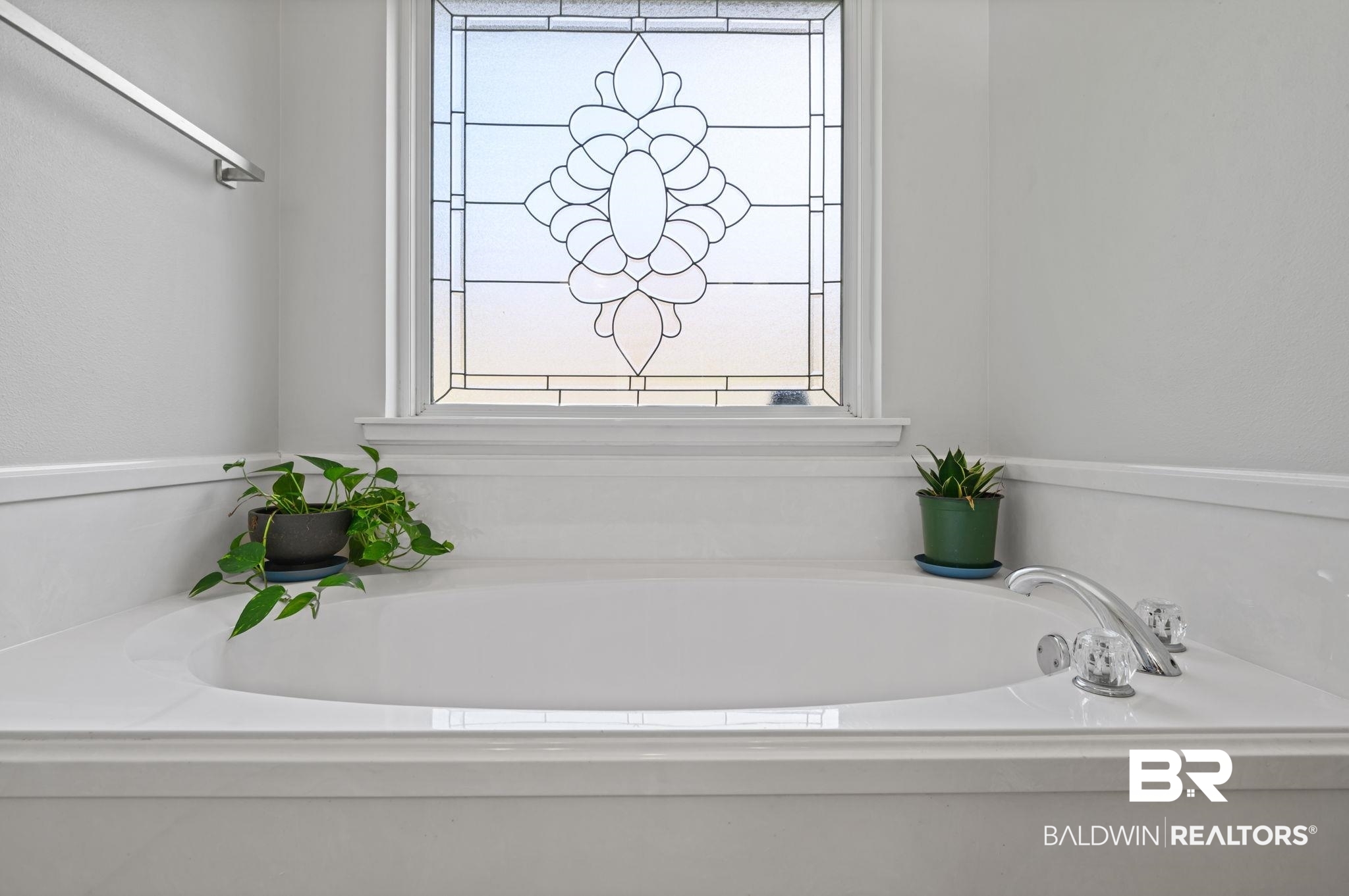 9422 Labrador Run South Mobile, AL 36695 - Photo 22 of 36 Soaking tub featuring a decorative frosted privacy window, polished chrome faucet, and clear acrylic handles