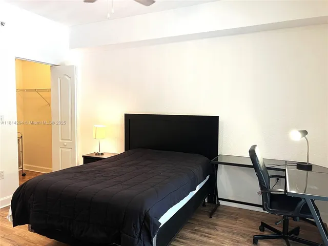 a bedroom with a bed and a table