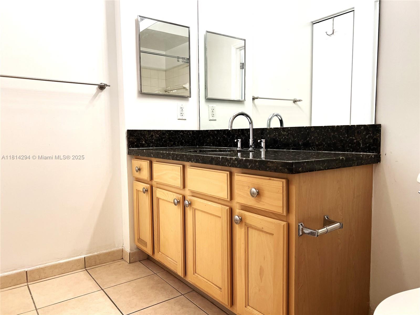 6001 Southwest 70th Street, Unit 252 South Miami, FL 33143 - Photo 13 of 15 a bathroom with a sink a mirror and a shower